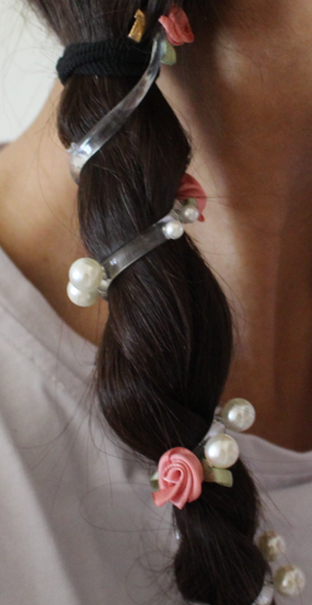 telephone cord rose hair tie in my braid close-up
