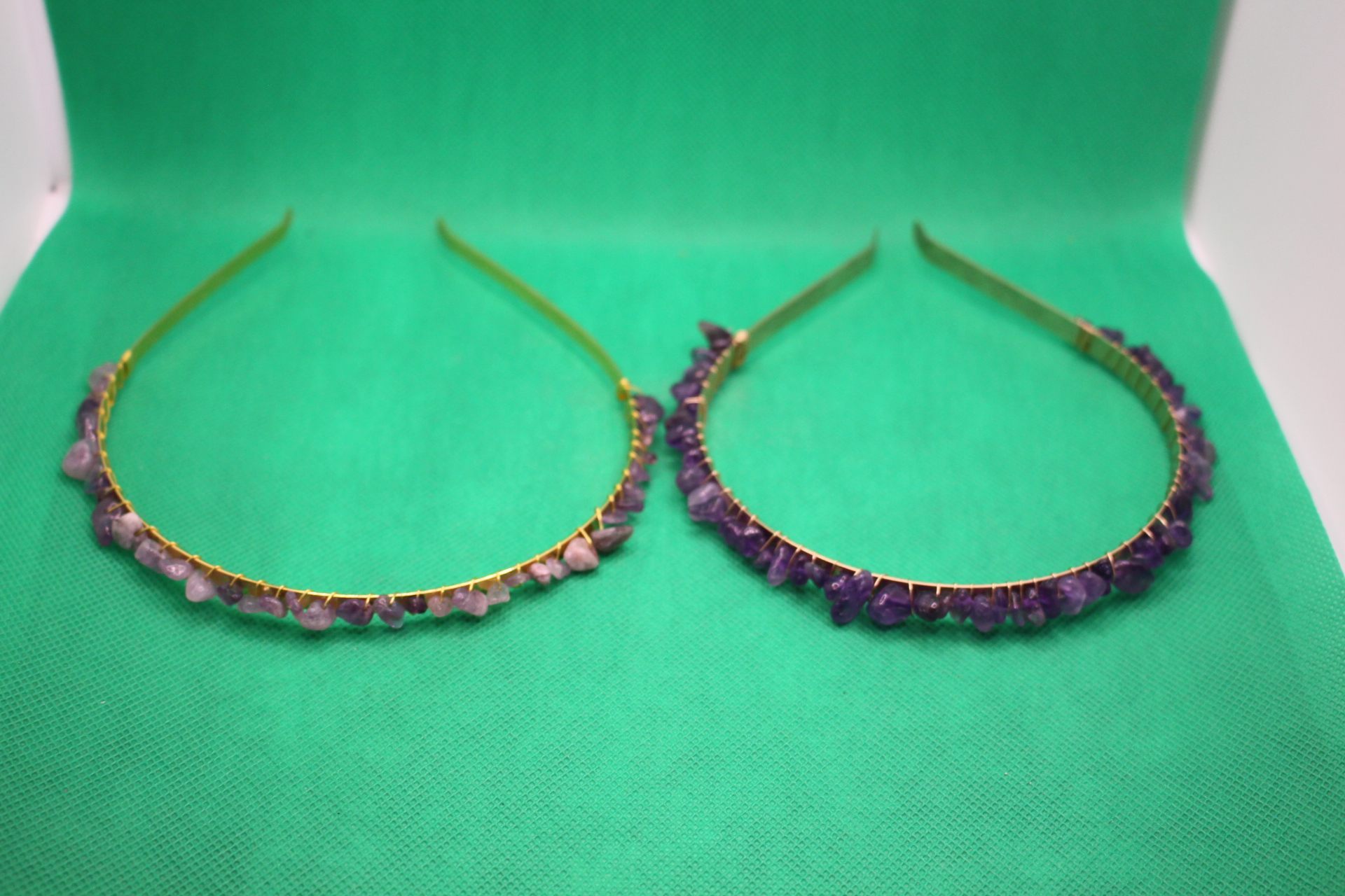 side by side comparison of new and old amethyst crystal headbands, with new one on the right, overhead shot