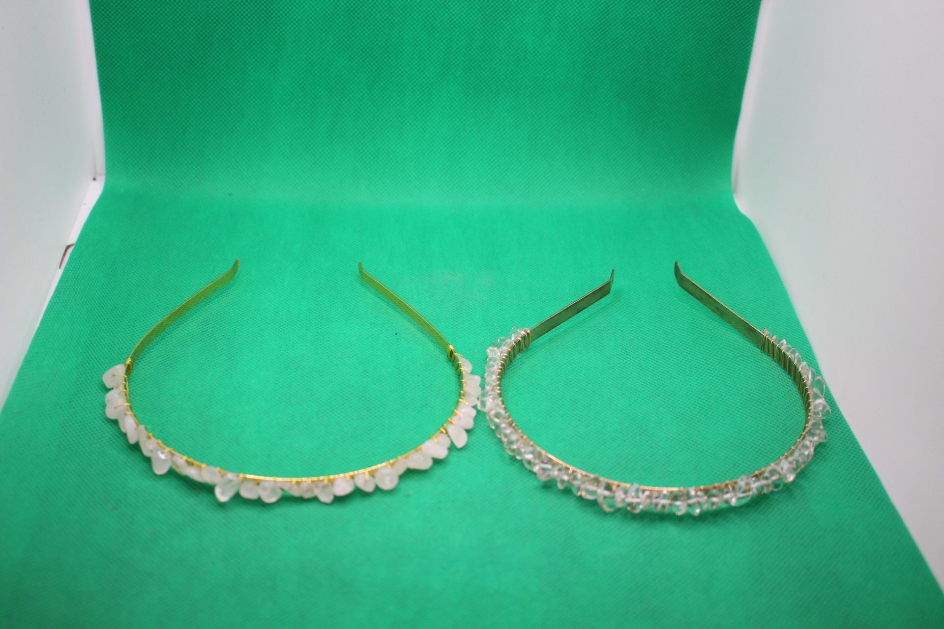 side-by-side comparison of clear quartz crystal headbands, with new one on the left, overhead shot