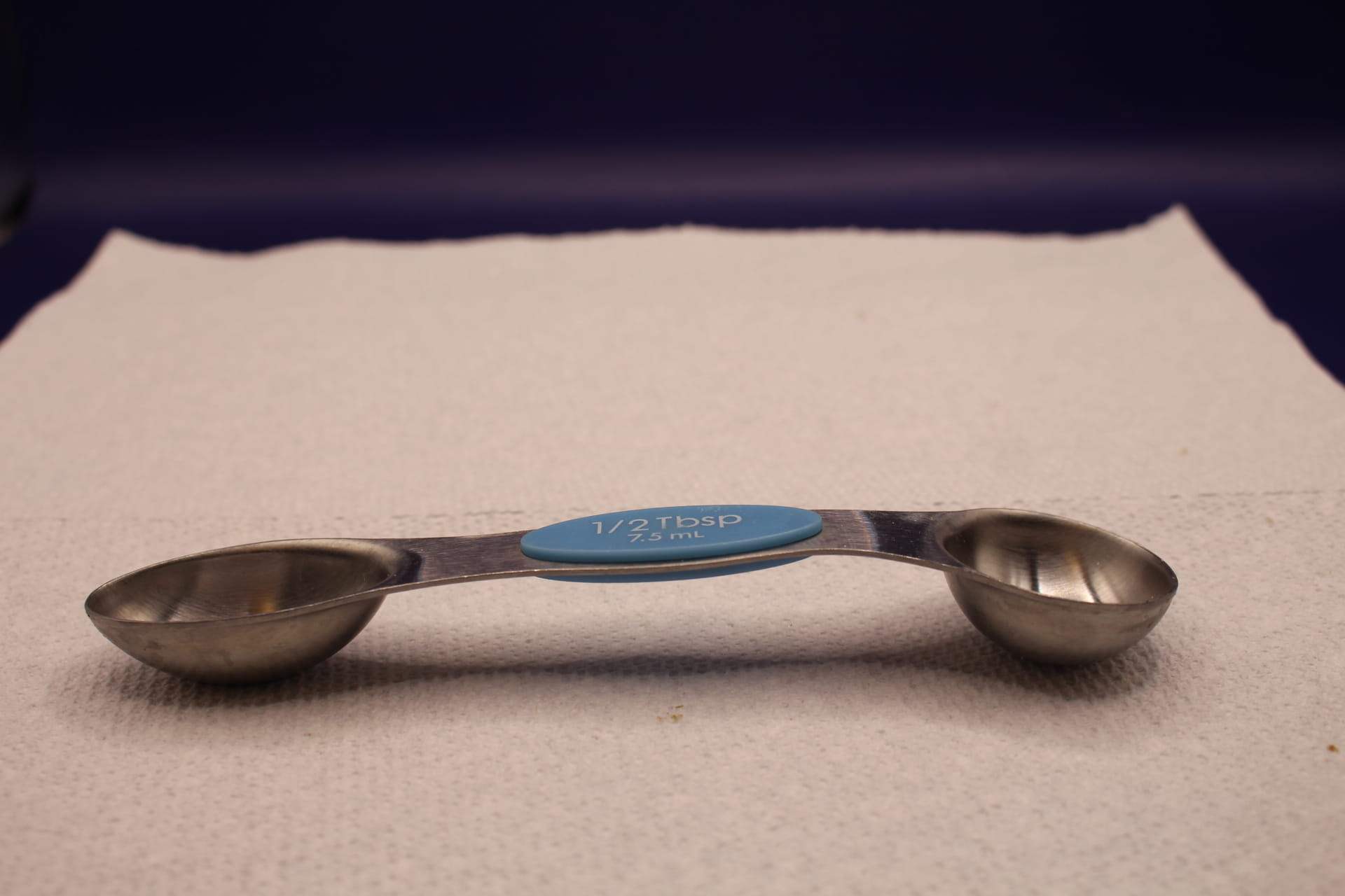 bent 1/2 tbsp double ended measuring spoon, scoop side up