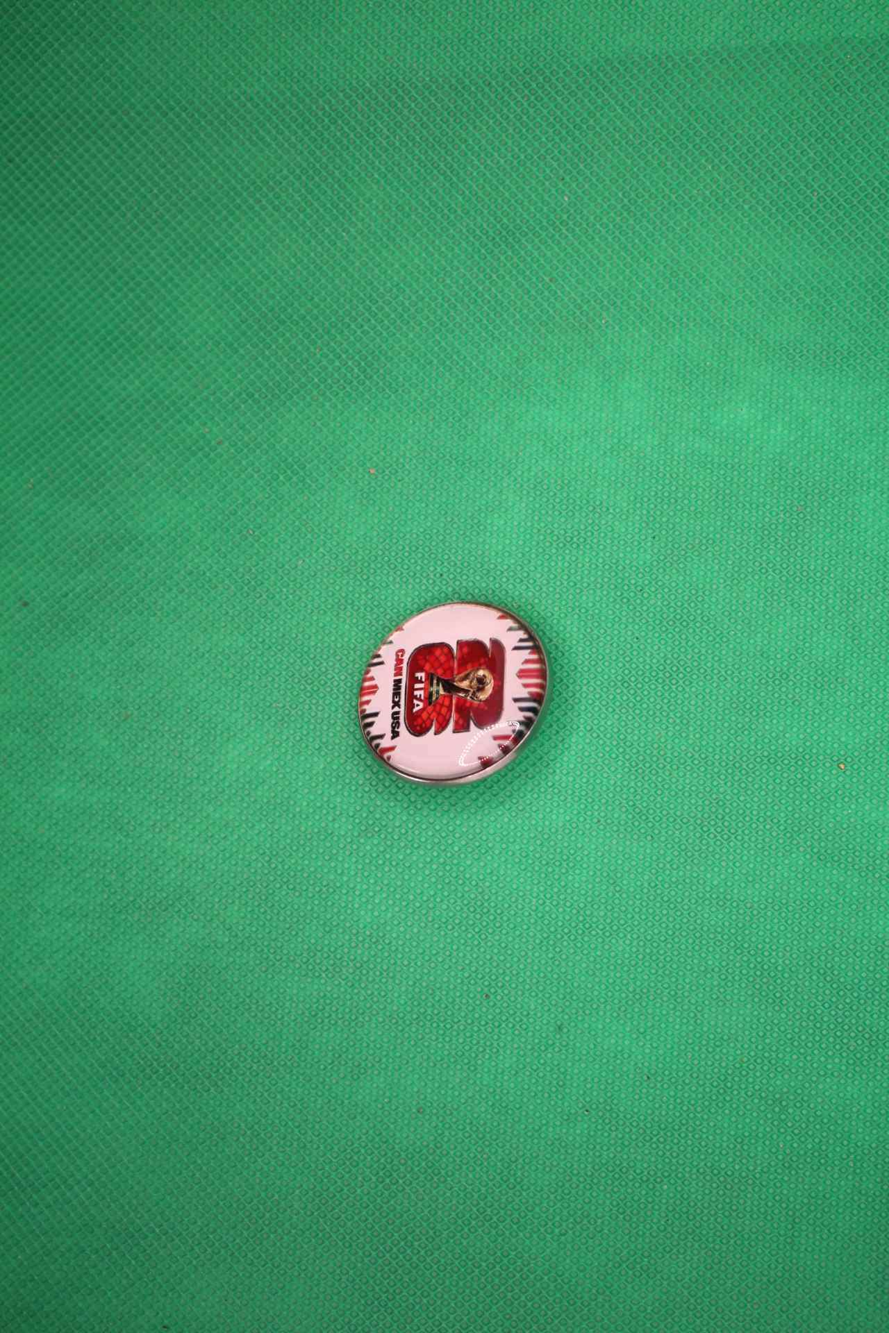 FIFA World Cup 2026 brooch pin with official logo image, side view