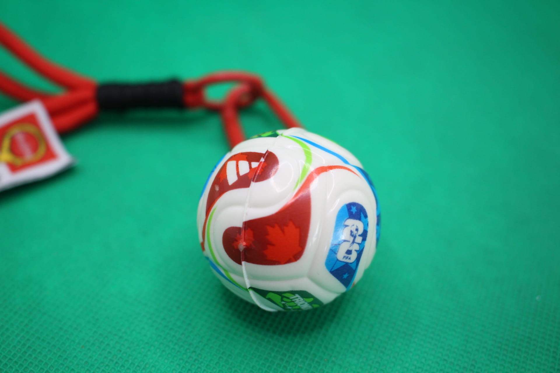 FIFA World Cup 2026 ball keychain, soccer ball focus, unaligned red Canadian maple leaf section