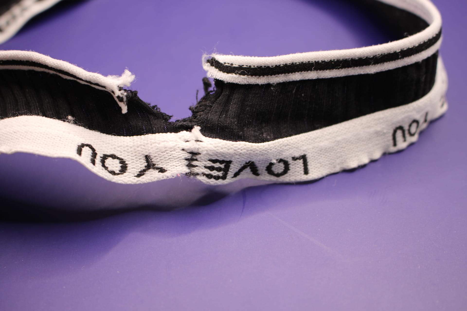 close-up of rip in black cotton LOVE YOU panties for women from Temu