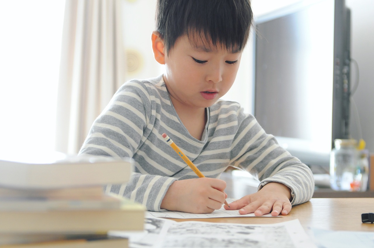 boy writing on sheet
