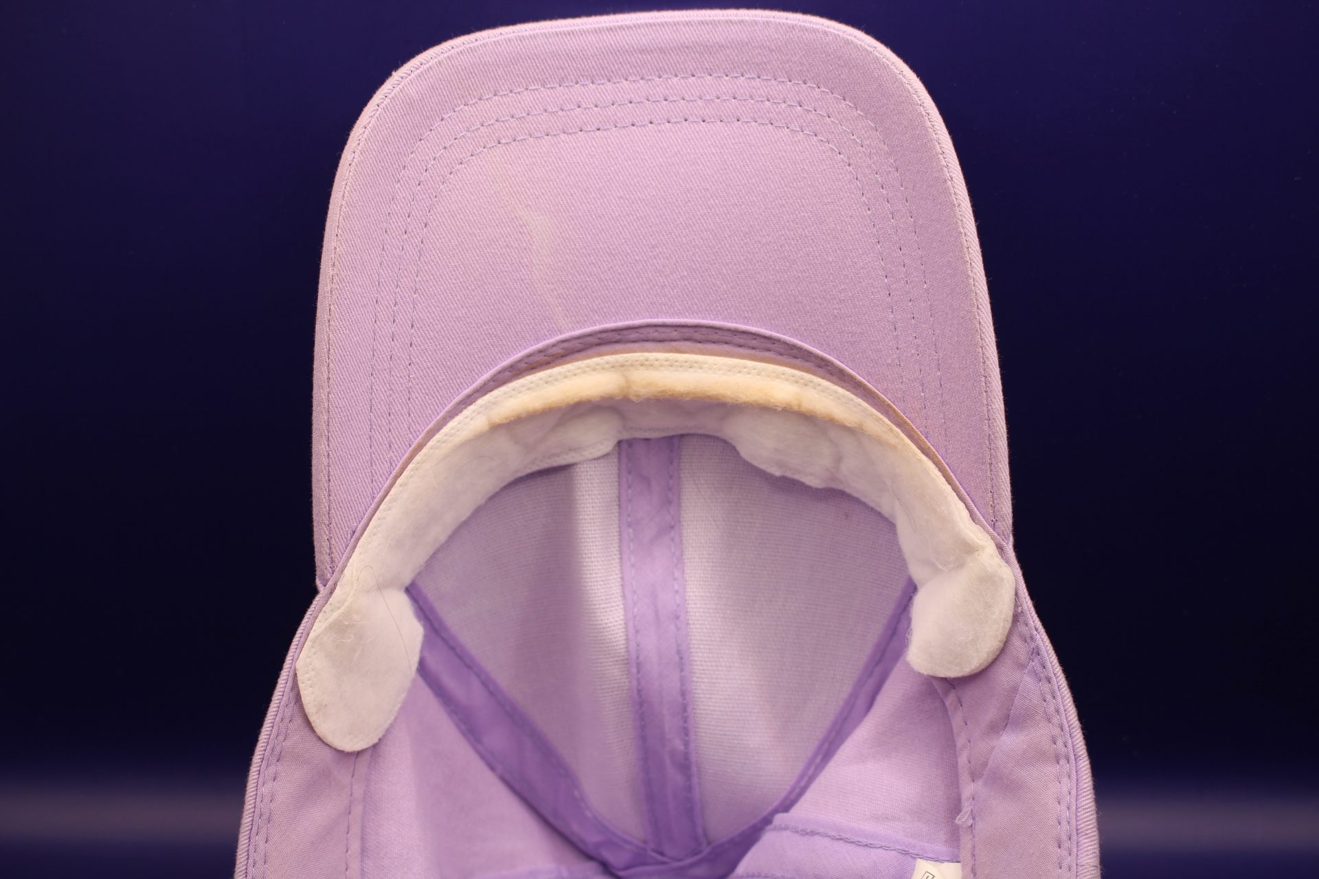white hat liner on my hat, showing foundation and makeup stains from it protecting my hat from my makeup
